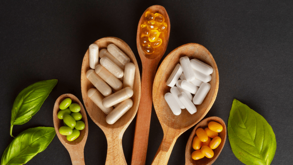 Wooden spoons filled with probiotic pills, supplements, and green soybeans, symbolizing probiotic foods vs. pills.